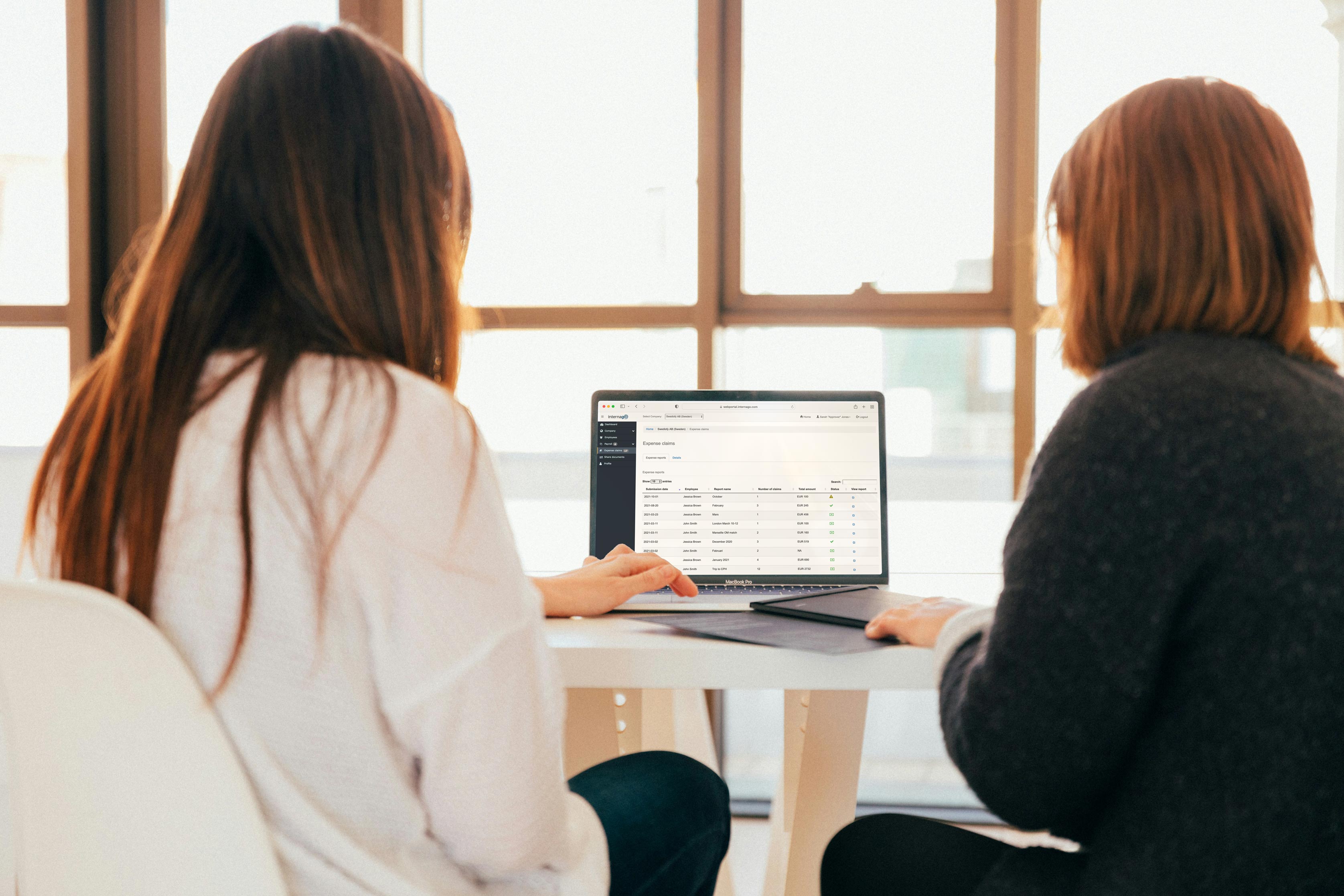 The image captures a dynamic scene of two motivated individuals actively working together on a project,that symbolize data-driven decision-making.