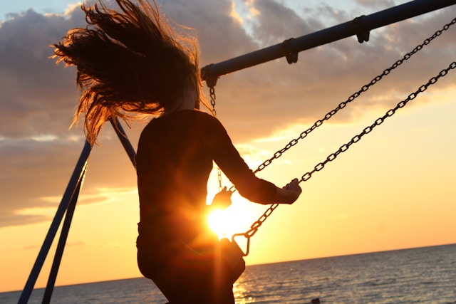 Person on swing in sunset symbolise Dutch pension