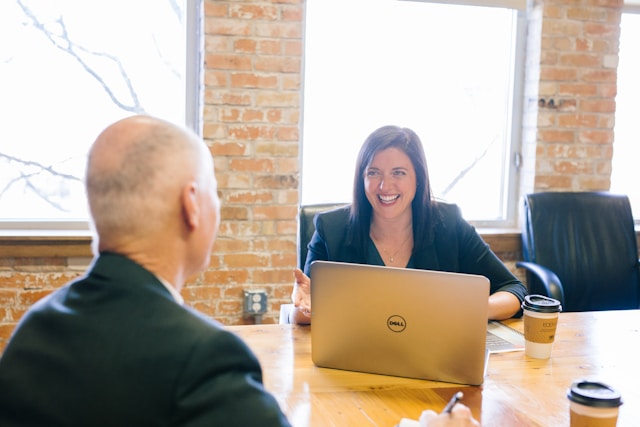 Two people at a desk discussing EOR vs. Foreign Employer setup.